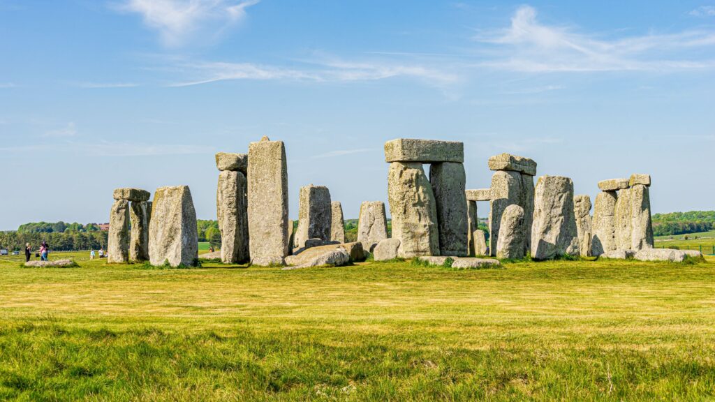 Stonehenge with blue skies and green grass