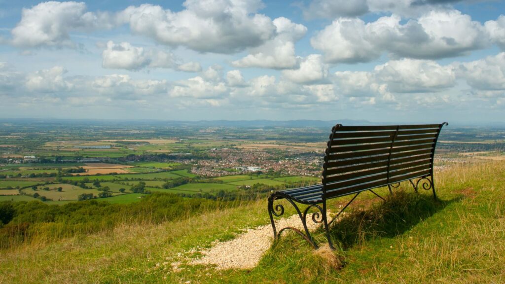 Bench overlooking countryside on top of hill - somewhere to sit while listening to podcasts