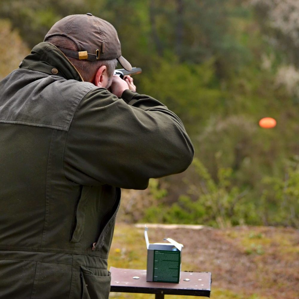 man with a hat doing clay pigeon shooting