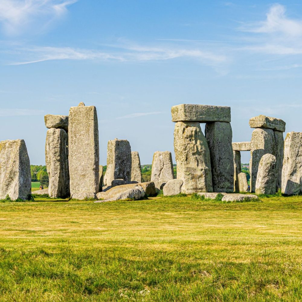 Stonehenge with blue skies and green grass